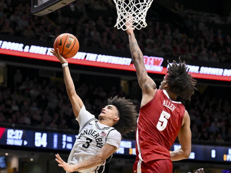 Jan 7, 2026; Nashville, Tennessee, USA;  Vanderbilt Commodores guard Tyler Tanner (3) lays the ball in overAlabama Crimson Tide forward Amari Allen (5) during the second half at Memorial Gymnasium. Mandatory Credit: Steve Roberts-Imagn Images