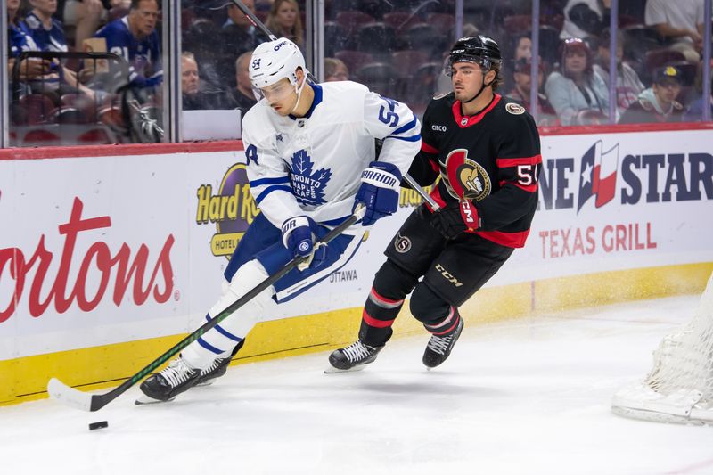 Sep 24, 2024; Ottawa, Ontario, CAN; Toronto Maple Leafs defenseman Nicolas Mattinen (54) skates with the puck in front of Ottawa Senators right wing Tytler Boucher (54) in the first period aat the Canadian Tire Centre. Mandatory Credit: Marc DesRosiers-Imagn Images