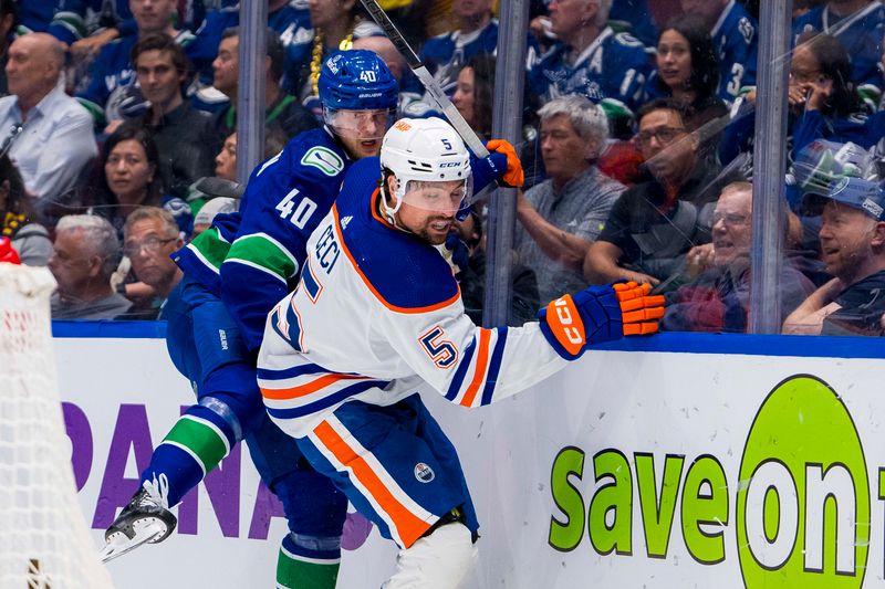 May 10, 2024; Vancouver, British Columbia, CAN; Vancouver Canucks forward Elias Pettersson (40) checks Edmonton Oilers defenseman Cody Ceci (5) during the first period in game two of the second round of the 2024 Stanley Cup Playoffs at Rogers Arena. Mandatory Credit: Bob Frid-USA TODAY Sports