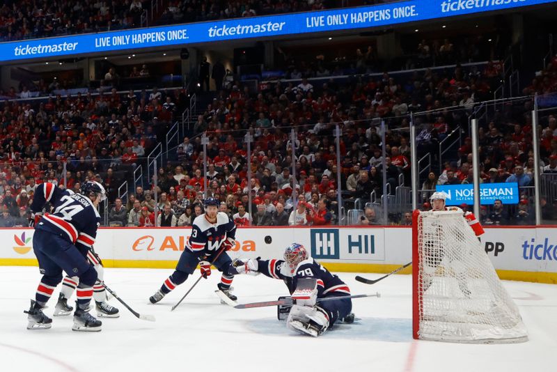 Mar 9, 2024; Washington, District of Columbia, USA; Washington Capitals goaltender Charlie Lindgren (79) makes a save as Capitals defenseman John Carlson (74) and Capitals defenseman Nick Jensen (3) look on against the Chicago Blackhawks in the first period at Capital One Arena. Mandatory Credit: Geoff Burke-USA TODAY Sports