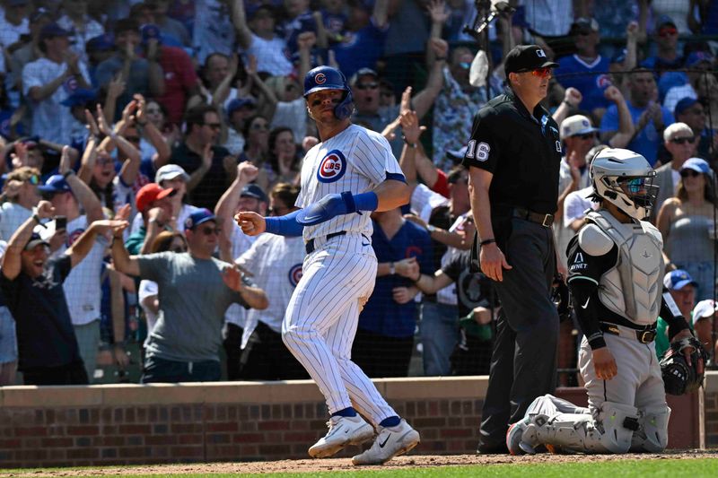 Jul 21, 2024; Chicago, Illinois, USA;  Chicago Cubs second base Nico Hoerner (2) scores against the Arizona Diamondbacks during the ninth inning at Wrigley Field. Mandatory Credit: Matt Marton-USA TODAY Sports