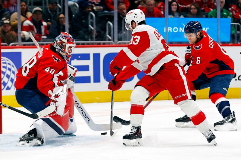 Mar 18, 2025; Washington, District of Columbia, USA; Detroit Red Wings right wing Alex DeBrincat (93) shoots the puck against Washington Capitals goaltender Logan Thompson (48) during the second period at Capital One Arena. Mandatory Credit: Peter Casey-Imagn Images