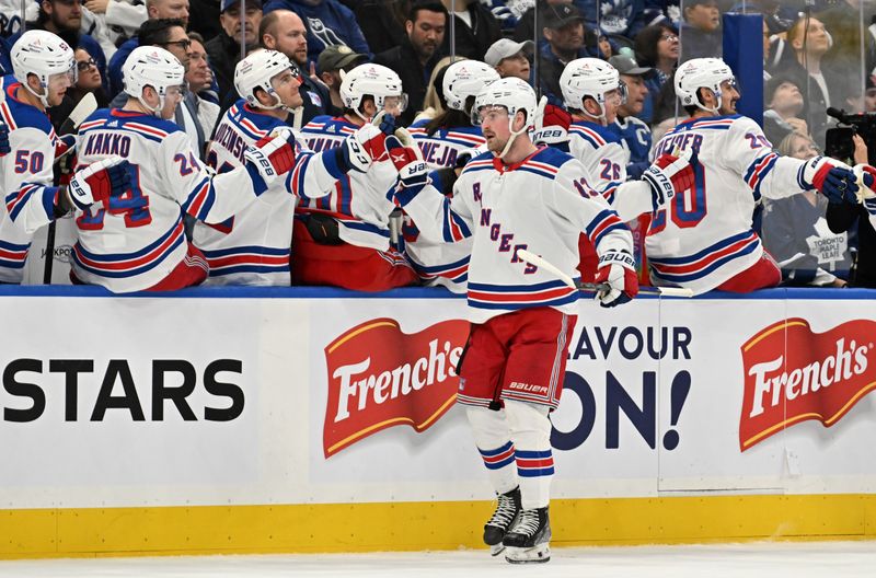 Mar 2, 2024; Toronto, Ontario, CAN;  New York Rangers forward Alexis Lafreniere (13) celebrates with team mates at the bench after scoring a goal against the Toronto Maple Leafs in the first period at Scotiabank Arena. Mandatory Credit: Dan Hamilton-USA TODAY Sports