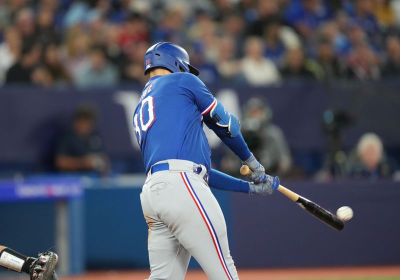 Sep 13, 2023; Toronto, Ontario, CAN; Texas Rangers first baseman Nathaniel Lowe (30) hits a single against the Toronto Blue Jays during the sixth inning at Rogers Centre. Mandatory Credit: Nick Turchiaro-USA TODAY Sports