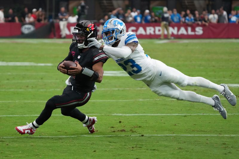 Arizona Cardinals quarterback Kyler Murray (1) rushes for a first down as Detroit Lions cornerback Carlton Davis III (23) defends during the second half of an NFL football game Sunday, Sept. 22, 2024, in Glendale, Ariz. (AP Photo/Rick Scuteri)