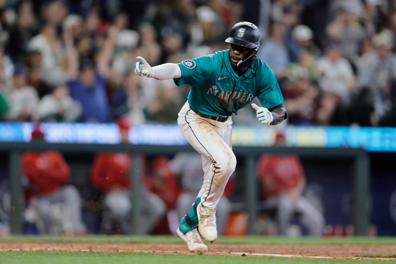 Jun 1, 2024; Seattle, Washington, USA;  Seattle Mariners second baseman Ryan Bliss runs to first after hitting a single against the Los Angeles Angels during the sixth inning at T-Mobile Park. Mandatory Credit: John Froschauer-USA TODAY Sports