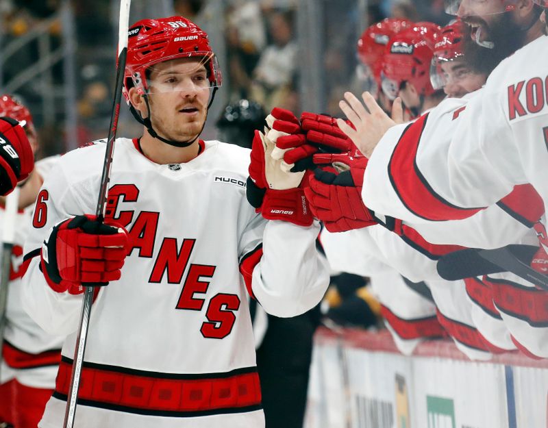 Oct 18, 2024; Pittsburgh, Pennsylvania, USA;  Carolina Hurricanes center Jack Roslovic (96) celebrates his goal with the Carolina bench against the Pittsburgh Penguins during the third period at PPG Paints Arena. Mandatory Credit: Charles LeClaire-Imagn Images