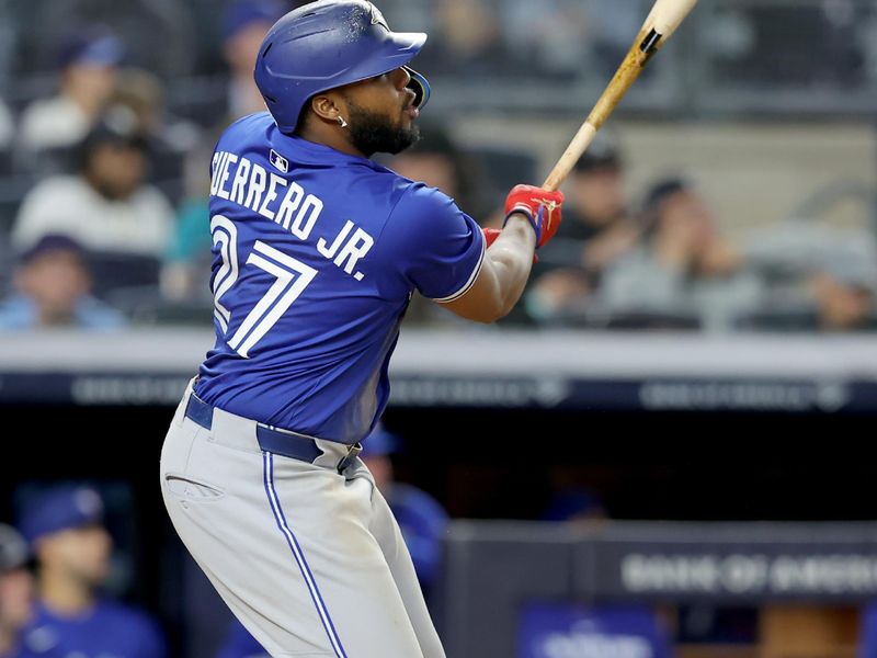 Apr 25, 2025; Bronx, New York, USA; Toronto Blue Jays first baseman Vladimir Guerrero Jr. (27) watches his solo home run against the New York Yankees during the sixth inning at Yankee Stadium. Mandatory Credit: Brad Penner-Imagn Images