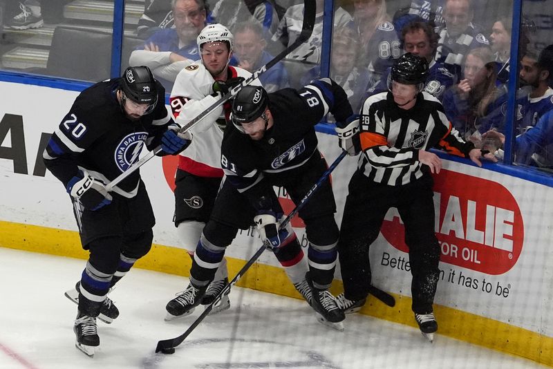 Feb 19, 2024; Tampa, Florida, USA; Tampa Bay Lightning left wing Nicholas Paul (20) and defenseman Erik Cernak (81) play for the puck against Ottawa Senators right wing Vladimir Tarasenko (91) during the second period at Amalie Arena. Mandatory Credit: Dave Nelson-USA TODAY Sports