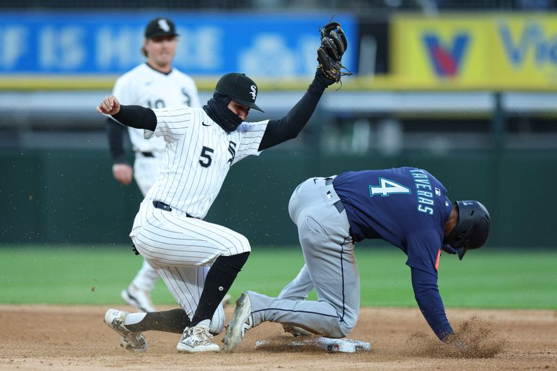 May 19, 2025; Chicago, Illinois, USA; Seattle Mariners right fielder Leody Taveras (4) is caught stealing second base by Chicago White Sox second baseman Josh Rojas (5) during the fifth inning at Rate Field. Mandatory Credit: Kamil Krzaczynski-Imagn Images