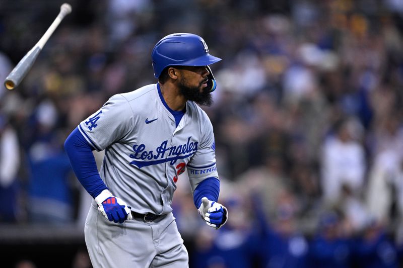 May 11, 2024; San Diego, California, USA; Los Angeles Dodgers left fielder Teoscar Hernandez (37) tosses hi bat after hitting a grand slam home run during the sixth inning against the San Diego Padres at Petco Park. Mandatory Credit: Orlando Ramirez-USA TODAY Sports