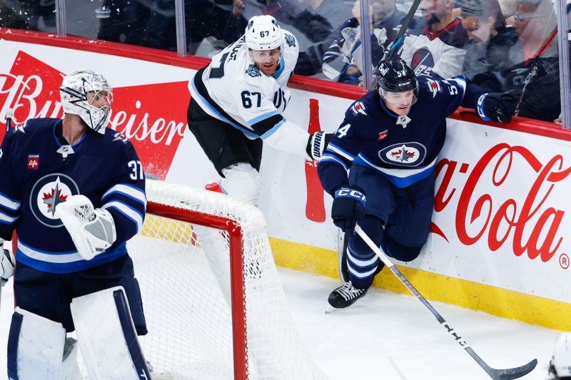 Nov 5, 2024; Winnipeg, Manitoba, CAN;  Winnipeg Jets defenseman Dylan Samberg (54) skates away from Utah Hockey Club forward Lawson Crouse (67) during the third period at Canada Life Centre. Mandatory Credit: Terrence Lee-Imagn Images