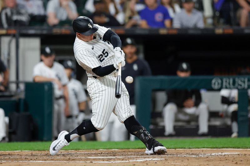 Aug 9, 2024; Chicago, Illinois, USA; Chicago White Sox first baseman Andrew Vaughn (25) hits a solo home run against the Chicago Cubs during the fourth inning at Guaranteed Rate Field. Mandatory Credit: Kamil Krzaczynski-USA TODAY Sports