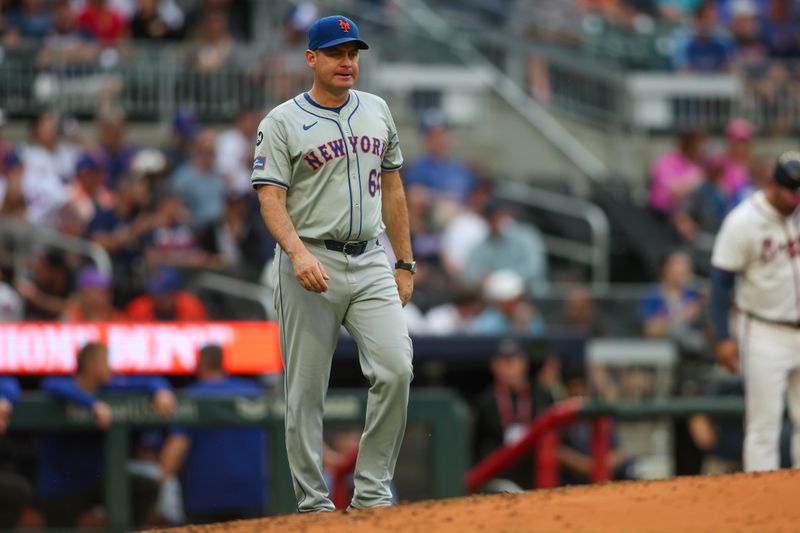 Sep 30, 2024; Atlanta, Georgia, USA; New York Mets manager Carlos Mendoza (64) makes a pitching change against the Atlanta Braves in the sixth inning at Truist Park. Mandatory Credit: Brett Davis-Imagn Images