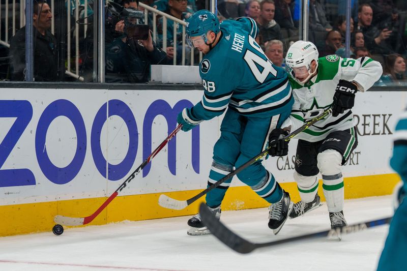 Jan 18, 2023; San Jose, California, USA;  San Jose Sharks center Tomas Hertl (48) and Dallas Stars center Wyatt Johnston (53) battle for the puck behind the net during the third period at SAP Center at San Jose. Mandatory Credit: Neville E. Guard-USA TODAY Sports