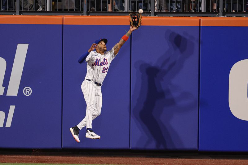 Apr 29, 2025; New York City, New York, USA; New York Mets left fielder Jose Azocar (28) leaps but can not catch a ball hit by Arizona Diamondbacks third baseman Eugenio Suarez (not pictured) during the eighth inning at Citi Field. Mandatory Credit: Vincent Carchietta-Imagn Images