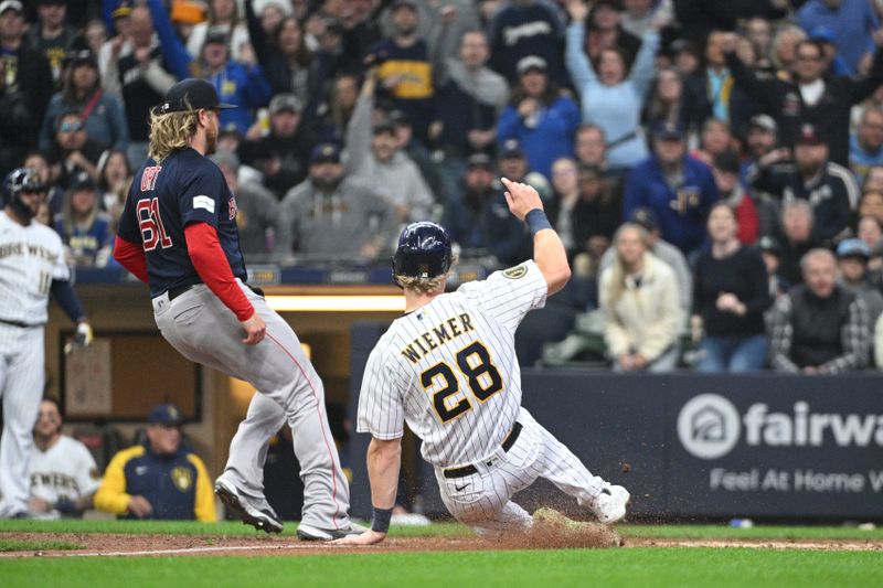 Apr 23, 2023; Milwaukee, Wisconsin, USA; Milwaukee Brewers right fielder Joey Wiemer (28) slides into home plate on a wild pitch by Boston Red Sox starting pitcher Brayan Bello (66) during the eighth inning at American Family Field. Mandatory Credit: Michael McLoone-USA TODAY Sports