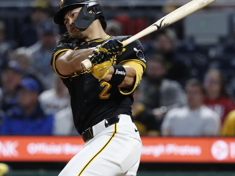 Apr 23, 2024; Pittsburgh, Pennsylvania, USA; Pittsburgh Pirates pinch hitter Connor Joe (2) hits a RBI single  against the Milwaukee Brewers during the sixth inning at PNC Park. Mandatory Credit: Charles LeClaire-USA TODAY Sports