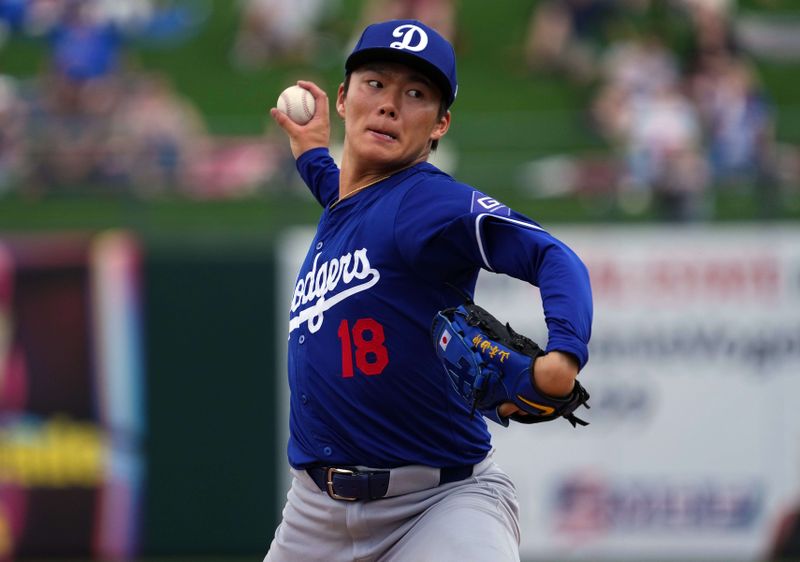 Feb 28, 2024; Surprise, Arizona, USA; Los Angeles Dodgers starting pitcher Yoshinobu Yamamoto (18) pitches during the first inning against the Texas Rangers at Surprise Stadium. Mandatory Credit: Joe Camporeale-USA TODAY Sports