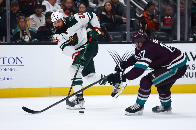 Mar 19, 2024; Anaheim, California, USA; Minnesota Wild defenseman Zach Bogosian (24) passes the puck against the Anaheim Ducks during the third period of a game at Honda Center. Mandatory Credit: Jessica Alcheh-USA TODAY Sports