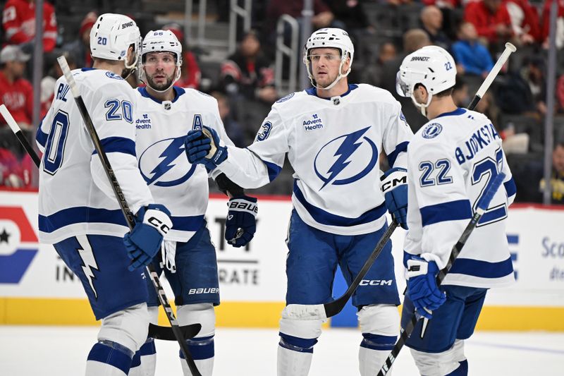 Nov 28, 2025; Detroit, Michigan, USA; Tampa Bay Lightning defenseman Darren Raddysh (43) celebrates his power play goal with teammates (from left) Nick Paul (20) Nikita Kucherov (86) and Oliver Bjorkstrand (22) against the Detroit Red Wings in the first period at Little Caesars Arena. Mandatory Credit: Lon Horwedel-Imagn Images