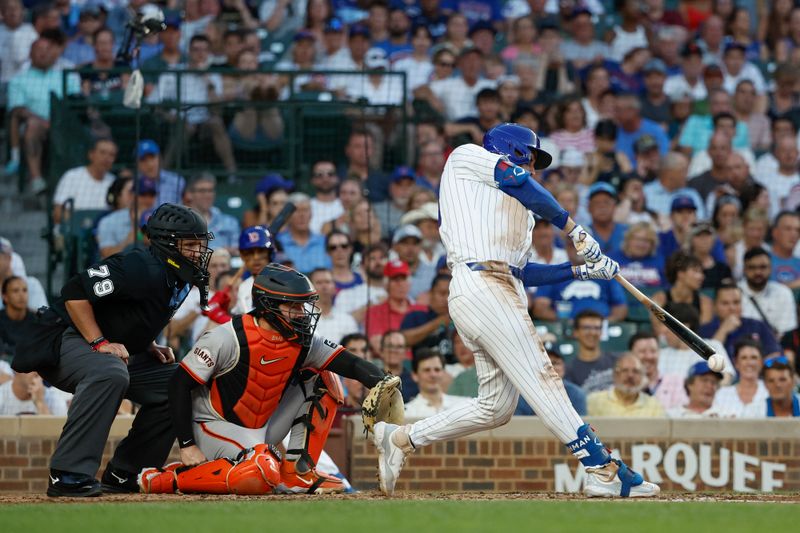 Jun 17, 2024; Chicago, Illinois, USA; Chicago Cubs outfielder Mike Tauchman (40) singles against the San Francisco Giants during the third inning at Wrigley Field. Mandatory Credit: Kamil Krzaczynski-USA TODAY Sports