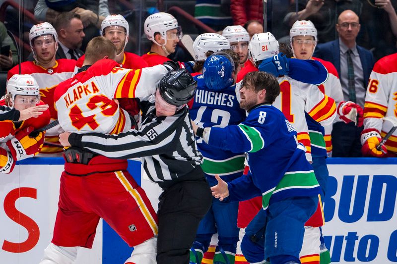 Apr 16, 2024; Vancouver, British Columbia, CAN; Calgary Flames forward Adam Klapka (43) wrestles with Vancouver Canucks forward Conor Garland (8) in the second period at Rogers Arena. Mandatory Credit: Bob Frid-USA TODAY Sports