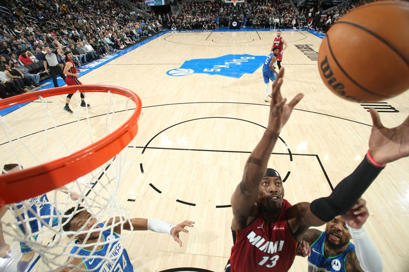 MILWAUKEE, WI - FEBRUARY 13: Bam Adebayo #13 of the Miami Heat rebounds the ball during the game against the Milwaukee Bucks on February 13, 2024 at the Fiserv Forum Center in Milwaukee, Wisconsin. NOTE TO USER: User expressly acknowledges and agrees that, by downloading and or using this Photograph, user is consenting to the terms and conditions of the Getty Images License Agreement. Mandatory Copyright Notice: Copyright 2024 NBAE (Photo by Gary Dineen/NBAE via Getty Images).