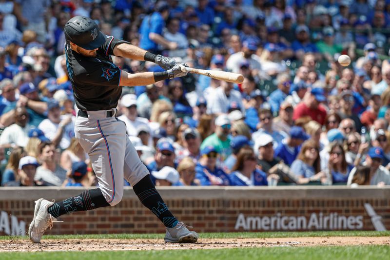 May 5, 2023; Chicago, Illinois, USA; Miami Marlins shortstop Garrett Hampson (1) singles against the Chicago Cubs during the second inning at Wrigley Field. Mandatory Credit: Kamil Krzaczynski-USA TODAY Sports