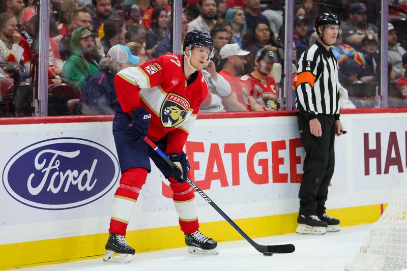 Nov 6, 2023; Sunrise, Florida, USA; Florida Panthers defenseman Niko Mikkola (77) controls the puck against the Columbus Blue Jackets during the first period at Amerant Bank Arena. Mandatory Credit: Sam Navarro-USA TODAY Sports