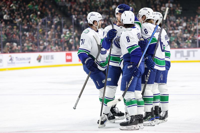 Dec 3, 2024; Saint Paul, Minnesota, USA; Vancouver Canucks defenseman Quinn Hughes (43) is congratulated for his goal by teammates during the first period against the Minnesota Wild at Xcel Energy Center. Mandatory Credit: Matt Krohn-Imagn Images