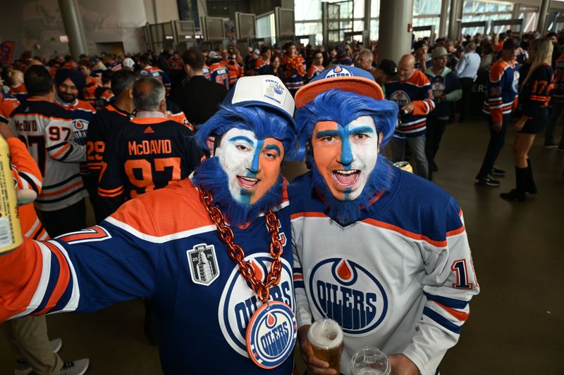 Jun 21, 2024; Edmonton, Alberta, CAN;  Dennis Martin and Dennias Dosedel from Slave Lake, Alberta cheer on the Oilers as the Edmonton Oilers take on the Florida Panthers  in game six of the 2024 Stanley Cup Final at Rogers Place. Mandatory Credit: Walter Tychnowicz-USA TODAY Sports