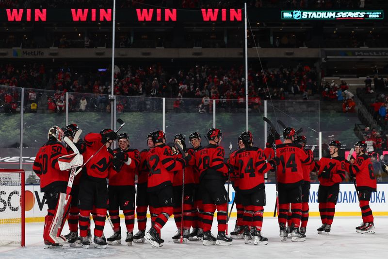 Feb 17, 2024; East Rutherford, New Jersey, USA; The New Jersey Devils celebrate their win over the Philadelphia Flyers in a Stadium Series ice hockey game at MetLife Stadium. Mandatory Credit: Ed Mulholland-USA TODAY Sports