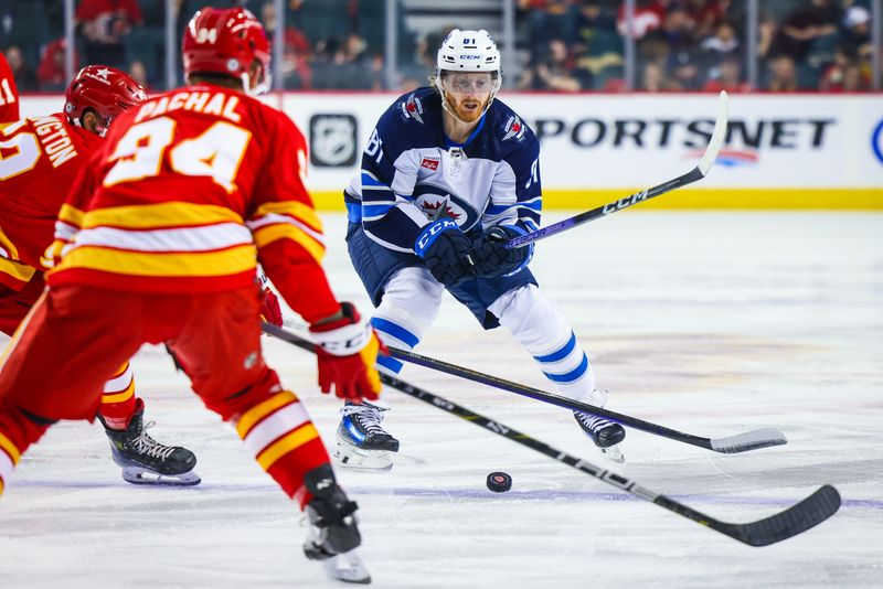 Feb 19, 2024; Calgary, Alberta, CAN; Winnipeg Jets left wing Kyle Connor (81) controls the puck against the Calgary Flames during the first period at Scotiabank Saddledome. Mandatory Credit: Sergei Belski-USA TODAY Sports