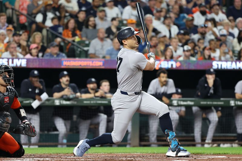 Sep 20, 2025; Baltimore, Maryland, USA; New York Yankees designated hitter Giancarlo Stanton (27) hits a home run during the first inning against the Baltimore Orioles at Oriole Park at Camden Yards. Mandatory Credit: Daniel Kucin Jr.-Imagn Images