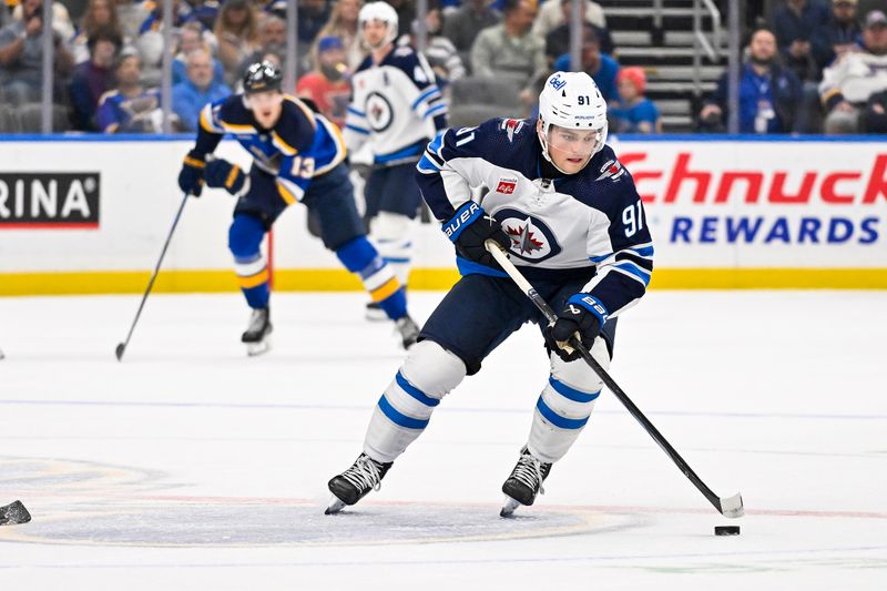 Nov 7, 2023; St. Louis, Missouri, USA;  Winnipeg Jets center Cole Perfetti (91) controls the puck against the St. Louis Blues during the first period at Enterprise Center. Mandatory Credit: Jeff Curry-USA TODAY Sports