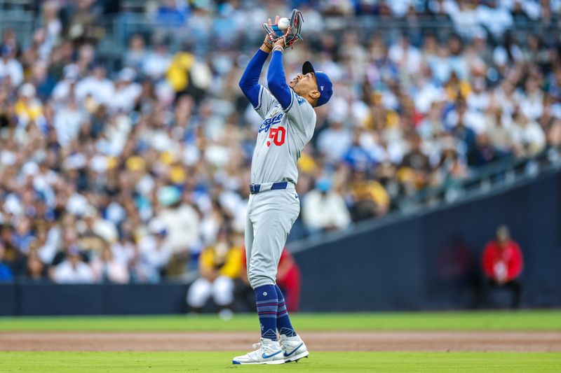 Jun 9, 2025; San Diego, California, USA;  Los Angeles Dodgers shortstop Mookie Betts (50) makes a ctach for an out during the first inning against the San Diego Padres at Petco Park. Mandatory Credit: David Frerker-Imagn Images