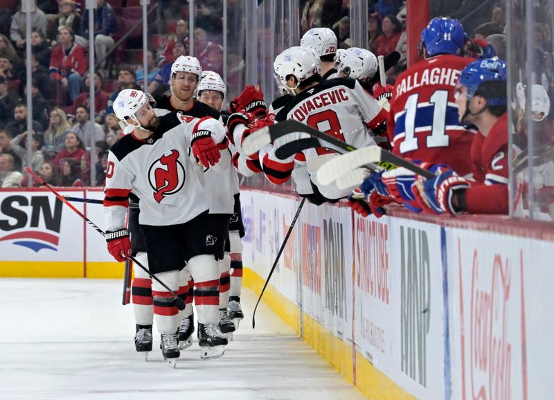 Jan 25, 2025; Montreal, Quebec, CAN; New Jersey Devils forward Tomas Tatar (90) celebrates with teammates after scoring a goal against the Montreal Canadiens during the second period at the Bell Centre. Mandatory Credit: Eric Bolte-Imagn Images