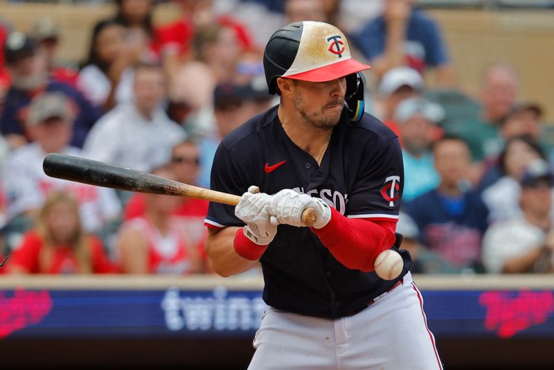 Sep 23, 2023; Minneapolis, Minnesota, USA; Minnesota Twins shortstop Kyle Farmer (12) is hit by a pitch by Los Angeles Angels in the ninth inning at Target Field. Mandatory Credit: Bruce Kluckhohn-USA TODAY Sports