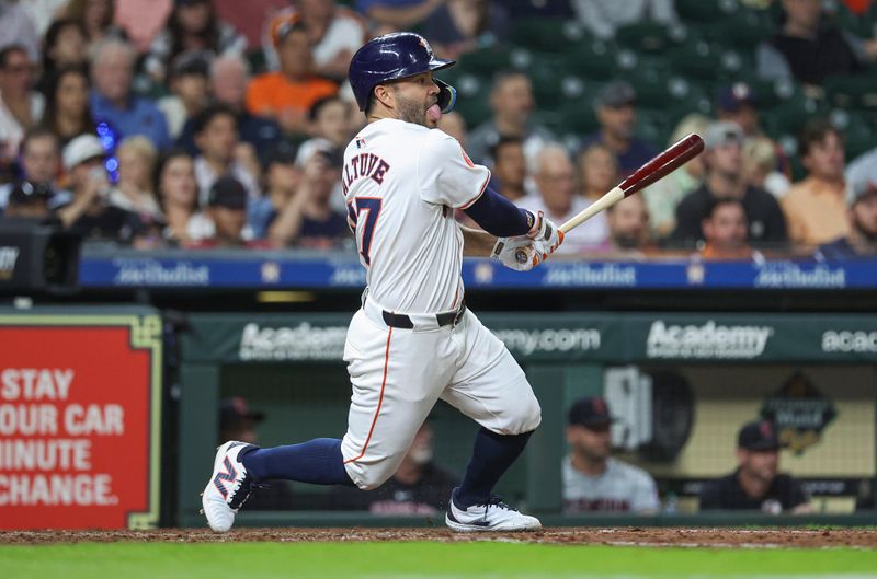 May 1, 2024; Houston, Texas, USA;  Houston Astros second baseman Jose Altuve (27) hits an RBI single during the sixth inning against the Cleveland Guardians at Minute Maid Park. Mandatory Credit: Troy Taormina-USA TODAY Sports