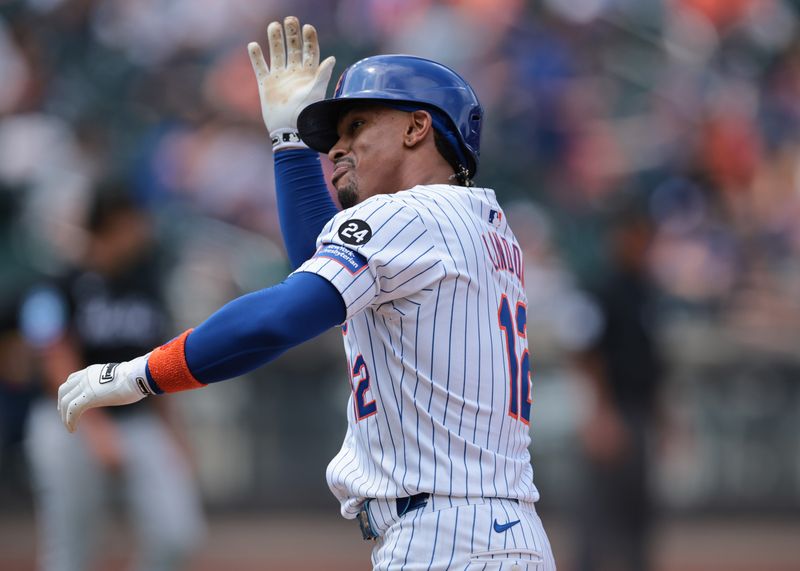 Aug 18, 2024; New York City, New York, USA; New York Mets shortstop Francisco Lindor (12) reacts after hitting an RBI single during the fifth inning against the Miami Marlins at Citi Field. Mandatory Credit: Vincent Carchietta-USA TODAY Sports