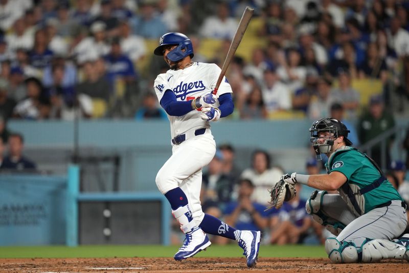 Aug 21, 2024; Los Angeles, California, USA; Los Angeles Dodgers right fielder Mookie Betts (50) hits a two-run double in the third inning against the Seattle Mariners at Dodger Stadium. Mandatory Credit: Kirby Lee-USA TODAY Sports