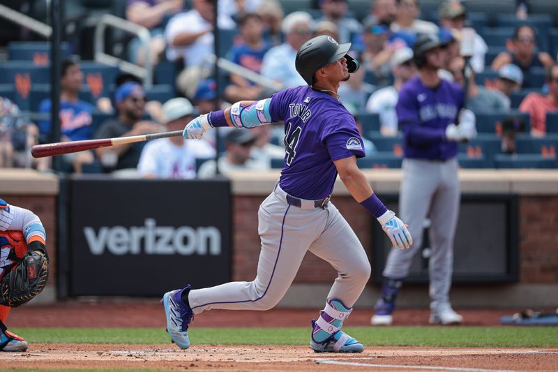 Jul 14, 2024; New York City, New York, USA;  Colorado Rockies shortstop Ezequiel Tovar (14) hits a two run home run during the first inning against the New York Mets at Citi Field. Mandatory Credit: Vincent Carchietta-USA TODAY Sports