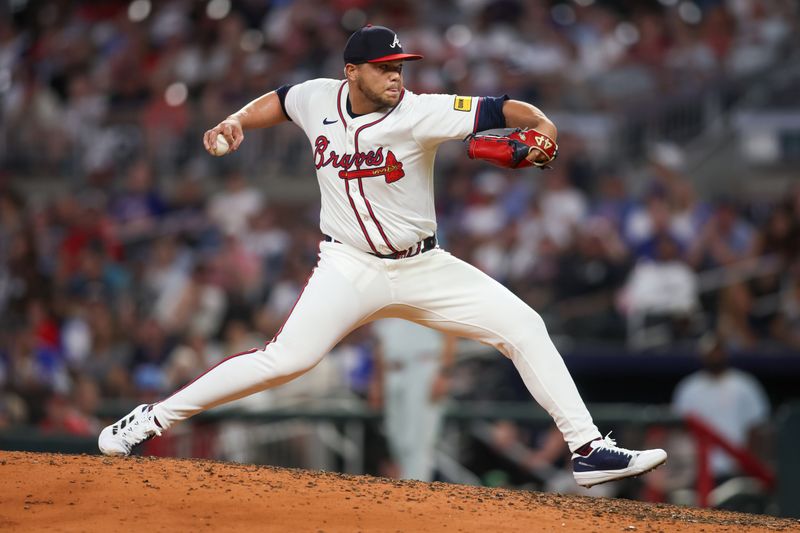 Aug 21, 2024; Atlanta, Georgia, USA; Atlanta Braves relief pitcher Joe Jimenez (77) throws against the Philadelphia Phillies in the seventh inning at Truist Park. Mandatory Credit: Brett Davis-USA TODAY Sports
