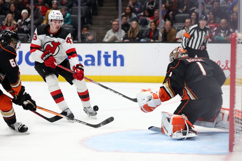 Mar 1, 2024; Anaheim, California, USA; New Jersey Devils defenseman Luke Hughes (43) attacks the goal against Anaheim Ducks goaltender Lukas Dostal (1) during the third period at Honda Center. Mandatory Credit: Kiyoshi Mio-USA TODAY Sports