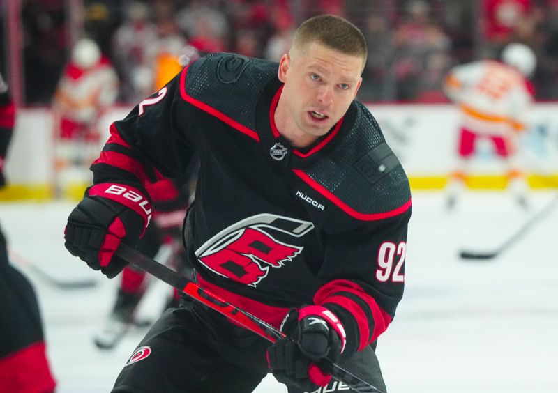 Mar 10, 2024; Raleigh, North Carolina, USA;  Carolina Hurricanes center Evgeny Kuznetsov (92) takes a shot during the warmups before the game against the Calgary Flames at PNC Arena. Mandatory Credit: James Guillory-USA TODAY Sports