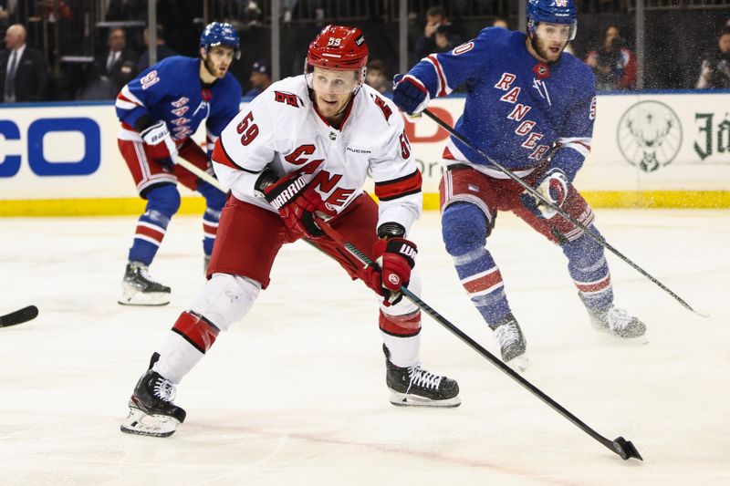 May 5, 2024; New York, New York, USA; Carolina Hurricanes center Jake Guentzel (59) controls the puck in the second period against the New York Rangers in game one of the second round of the 2024 Stanley Cup Playoffs at Madison Square Garden. Mandatory Credit: Wendell Cruz-USA TODAY Sports