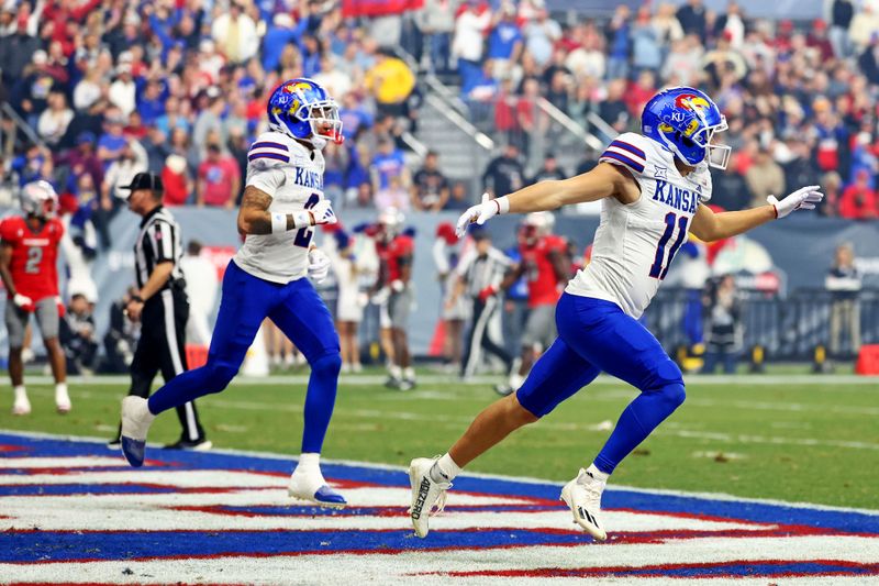 Dec 26, 2023; Phoenix, AZ, USA; Kansas Jayhawks wide receiver Luke Grimm (11) celebrates after scoring a touchdown during the second quarter against the UNLV Rebels in the Guaranteed Rate Bowl at Chase Field. Mandatory Credit: Mark J. Rebilas-USA TODAY Sports