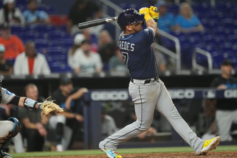 Aug 29, 2023; Miami, Florida, USA;  Tampa Bay Rays third baseman Isaac Paredes (17) hits a three-run home in the ninth inning against the Miami Marlins at loanDepot Park. Mandatory Credit: Jim Rassol-USA TODAY Sports