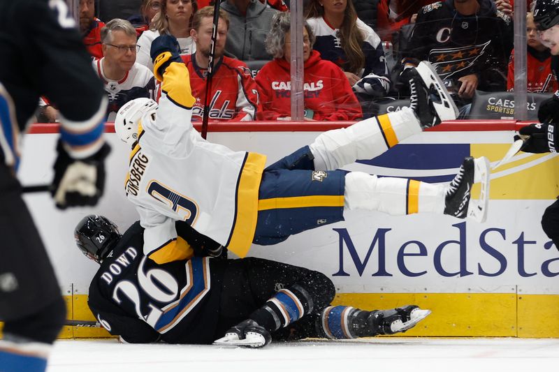 Nov 6, 2024; Washington, District of Columbia, USA; Washington Capitals center Nic Dowd (26) upends Nashville Predators left wing Filip Forsberg (9) in the second period at Capital One Arena. Mandatory Credit: Geoff Burke-Imagn Images